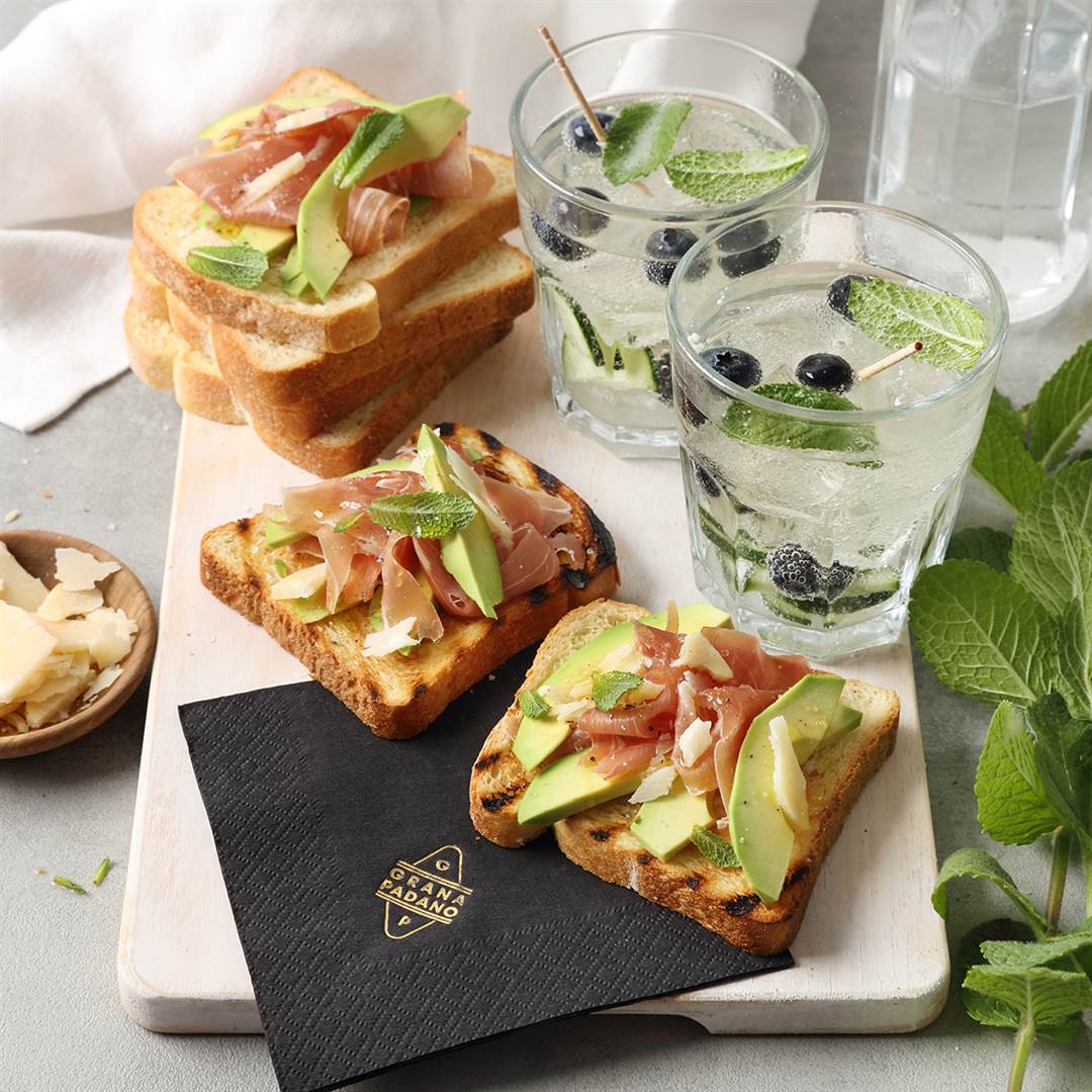 Cucumber, blueberry and lemon flavoured water & bruschetta with avocado, prosciutto and shavings of Grana Padano Riserva 