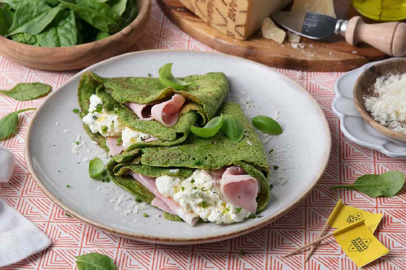 Green spinach crepes with ham and creamy ricotta and Grana Padano PDO filling