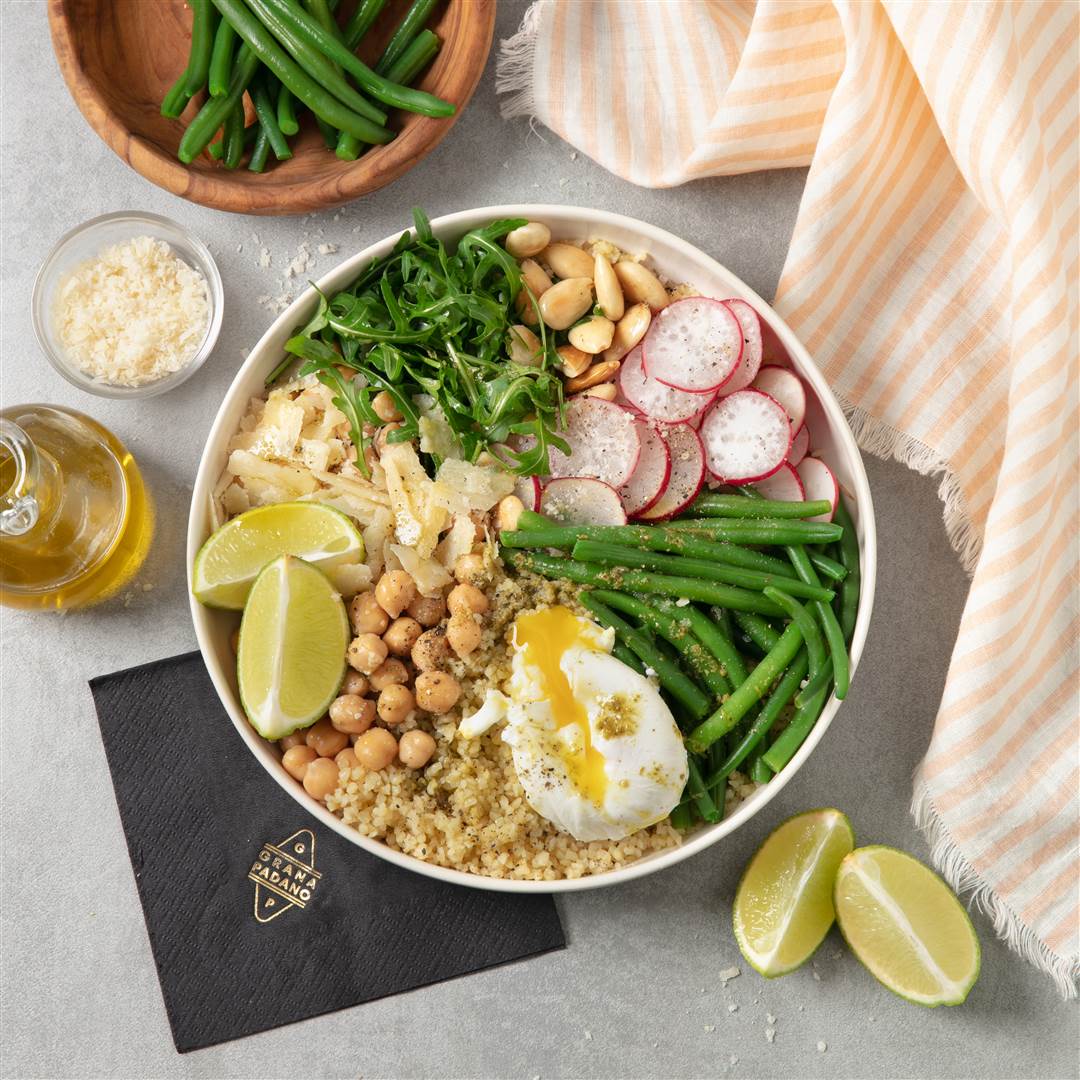 Couscous with poached egg, green beans, roasted almonds, chickpeas and basil, with Grana Padano Riserva