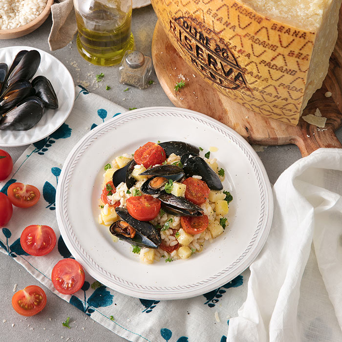 Reis mit Miesmuscheln, Kartoffeln, Tomaten und Grana Padano Riserva