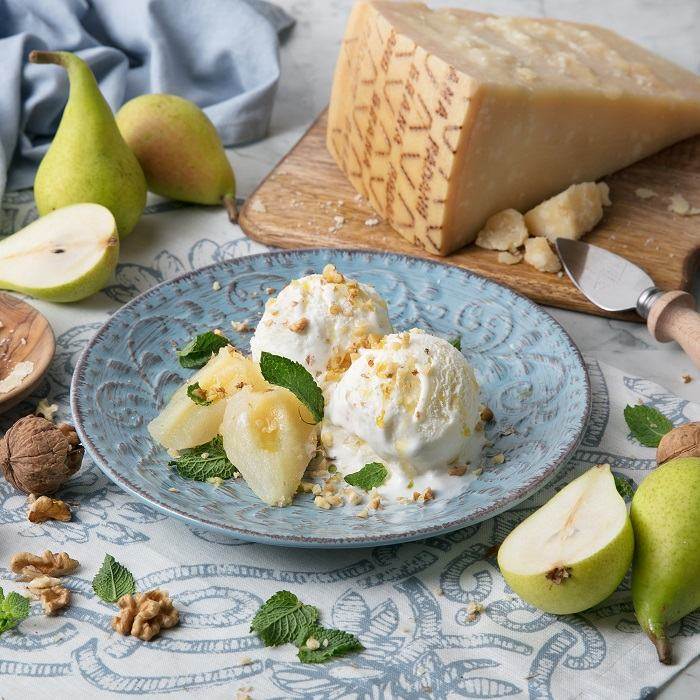 Grana Padano PDO ice cream with pears in syrup, chopped walnuts and fresh mint