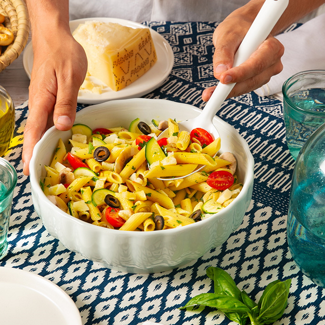 Summer pasta salad with grape tomatoes, courgettes, mushrooms, olives, and Grana Padano