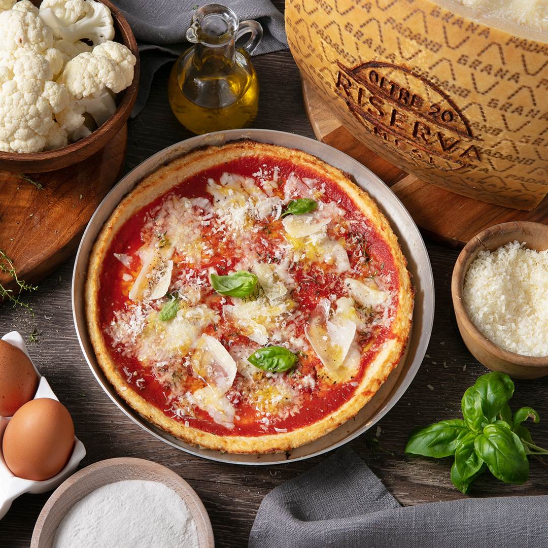 Pizza mit Blumenkohl-Grana Padano Riserva-Boden, belegt mit Tomatensauce, gegrilltem Gemüse und Grana Padano Riserva-Splittern