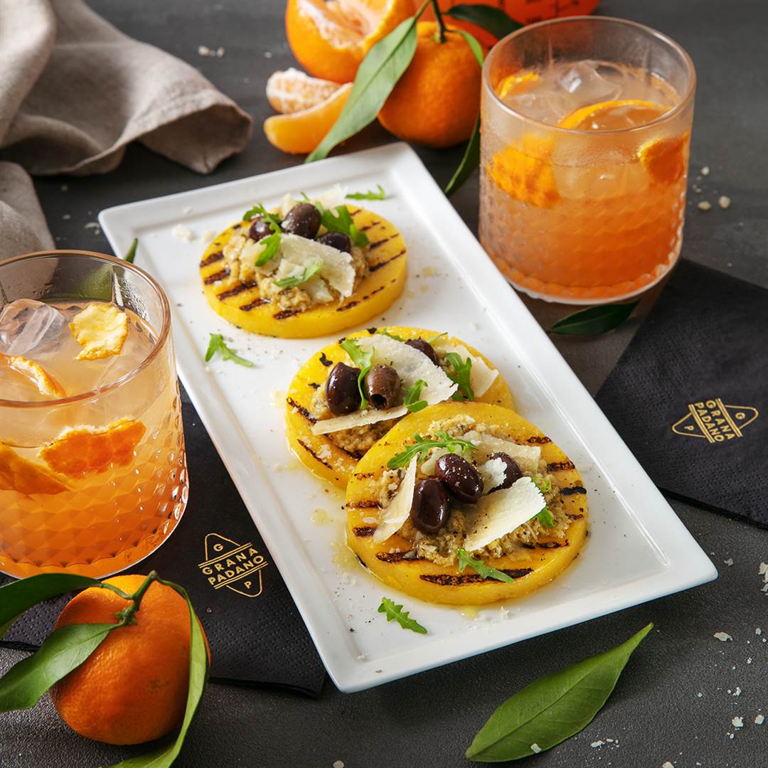 Grilled polenta with artichoke cream, taggiasche olives and Grana Padano + clementine and vermouth cocktail