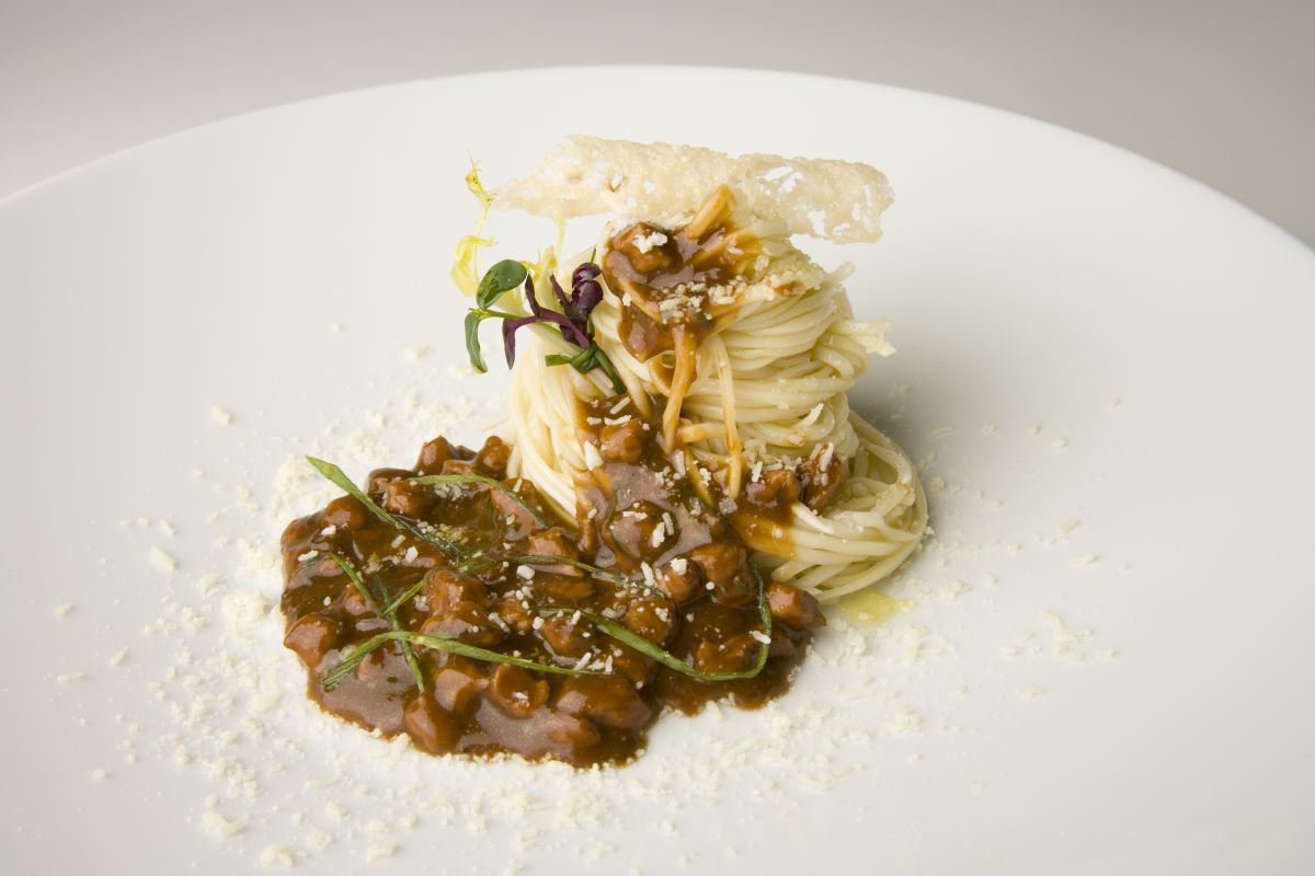 Pork meat fried in a bean curd with noodles and Grana Padano 