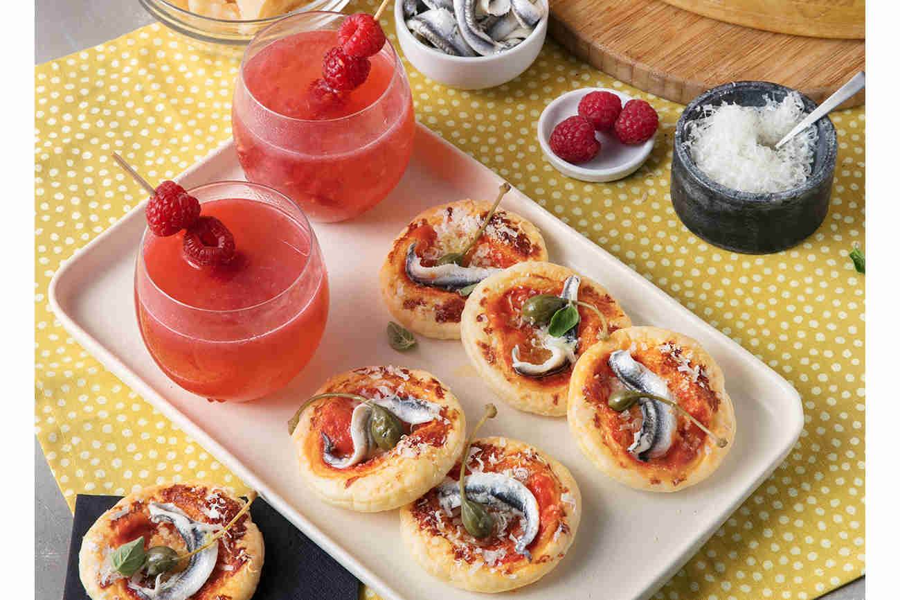 Raspberry Lemonade and Mini Pizzas topped with Tomato, Anchovies, Capers and Grana Padano Riserva 