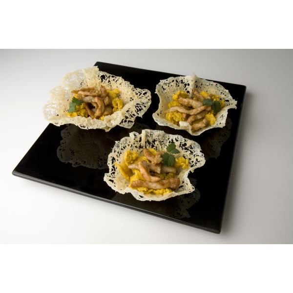 Scrambled eggs with pork slivers in Grana Padano baskets