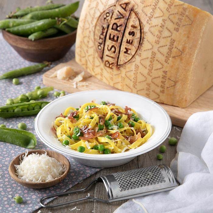 Tagliatelle with fresh peas, speck and shavings of Grana Padano Riserva