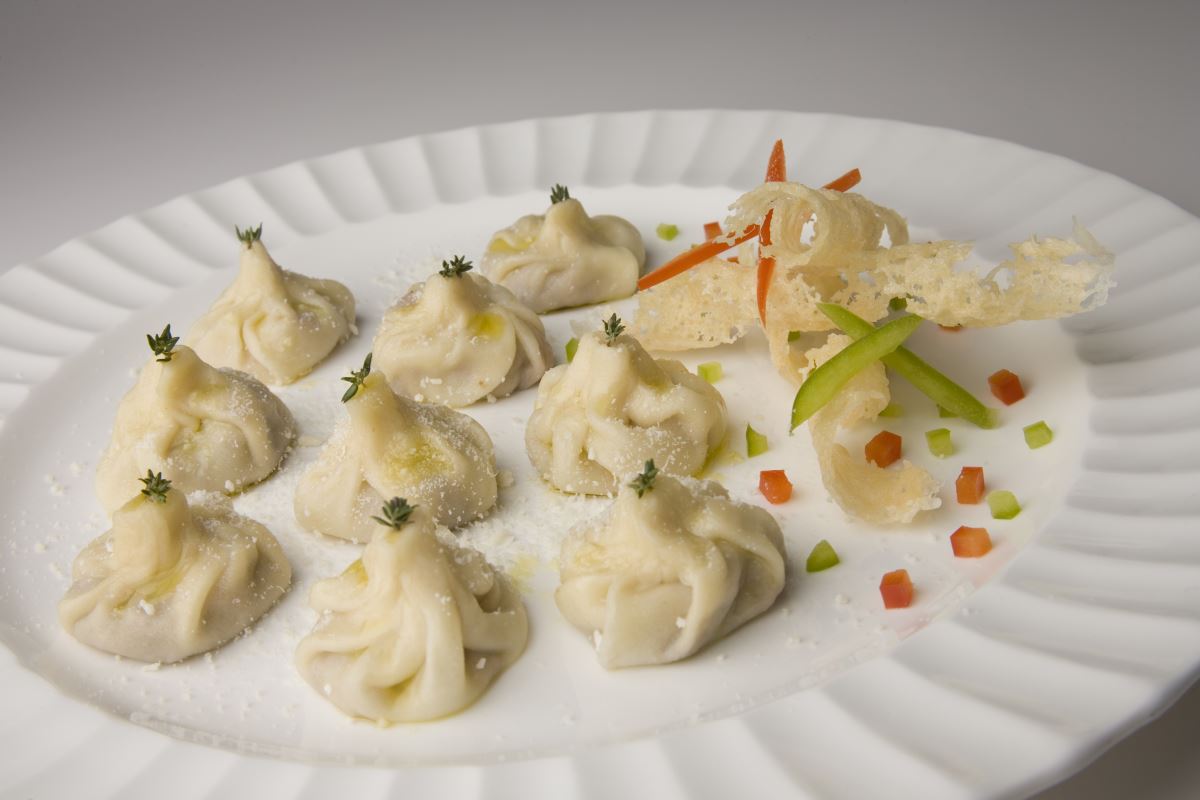 Tasty steamed dumplings with four cheese sauce