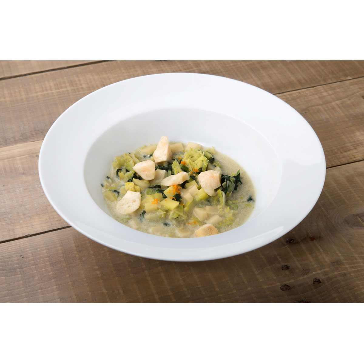 Sopa de verza y col negra, perlas de Grana Padano y corteza inflada