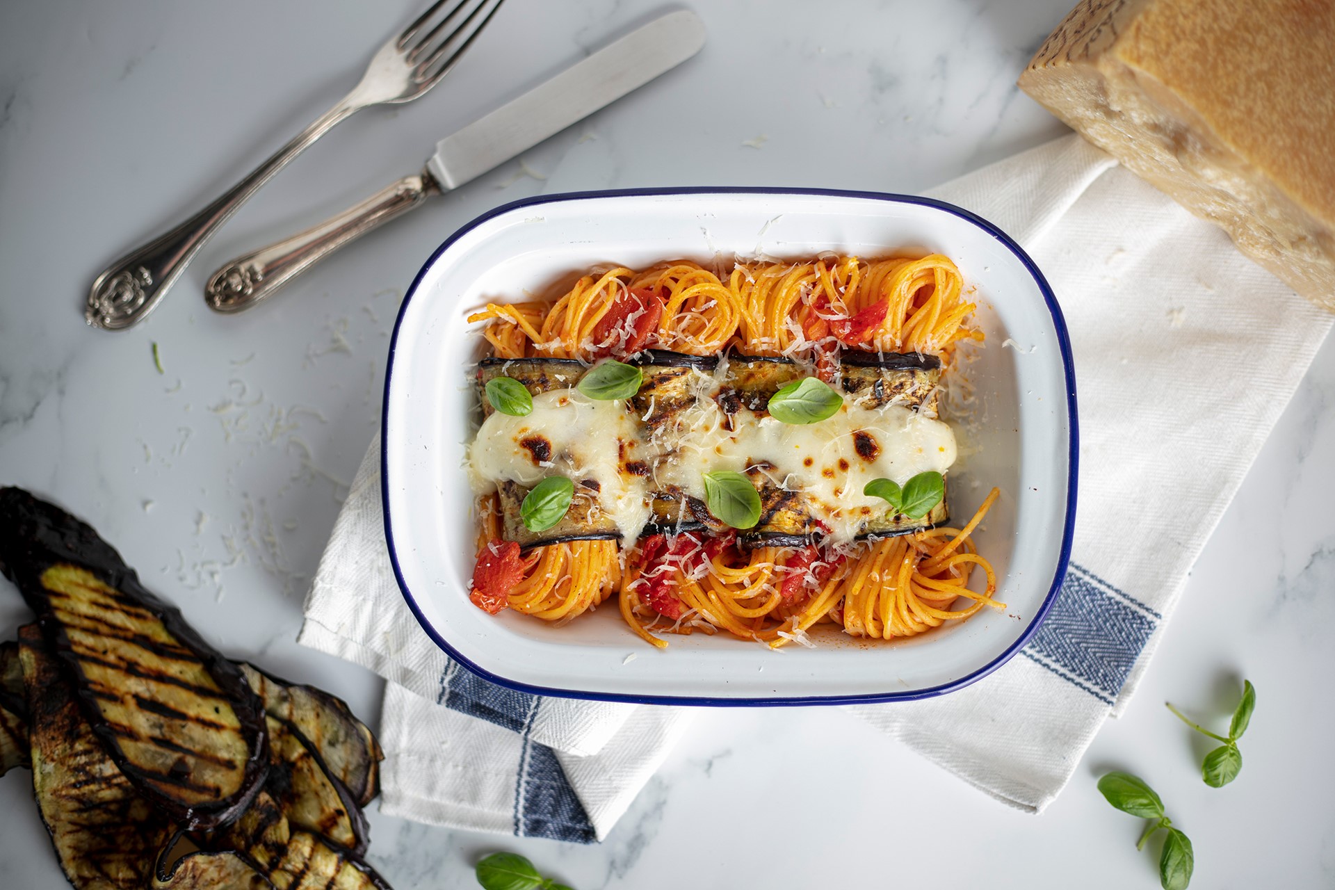 Baked spaghetti and Aubergine rolls with Grana Padano