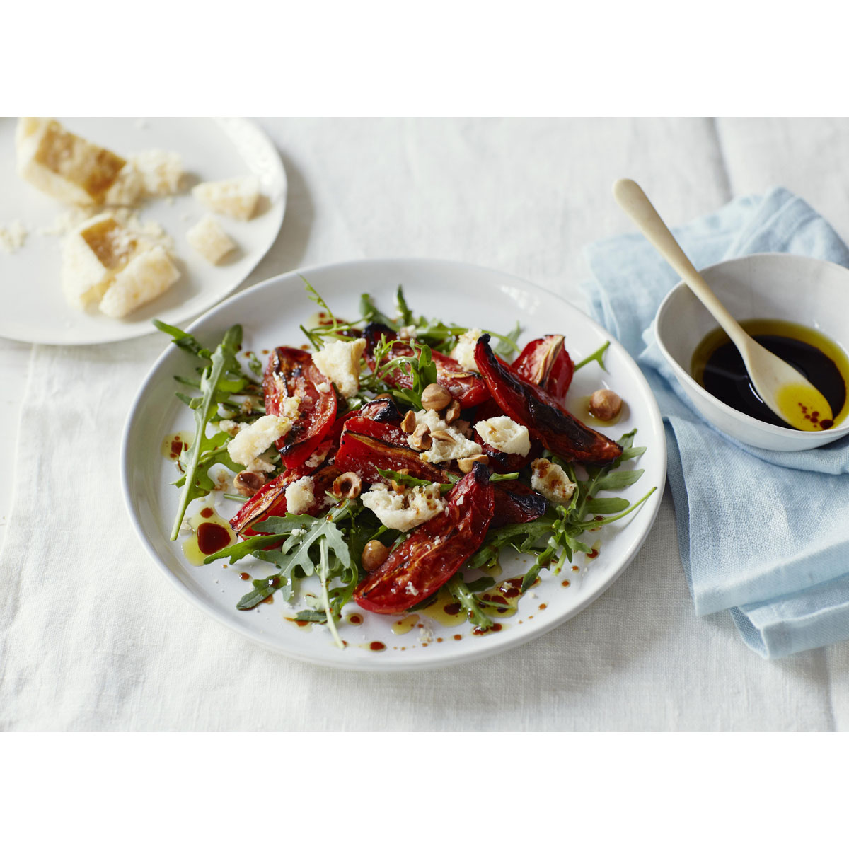 Grana Padano honeycomb with roasted tomatoes, rocket and hazelnut