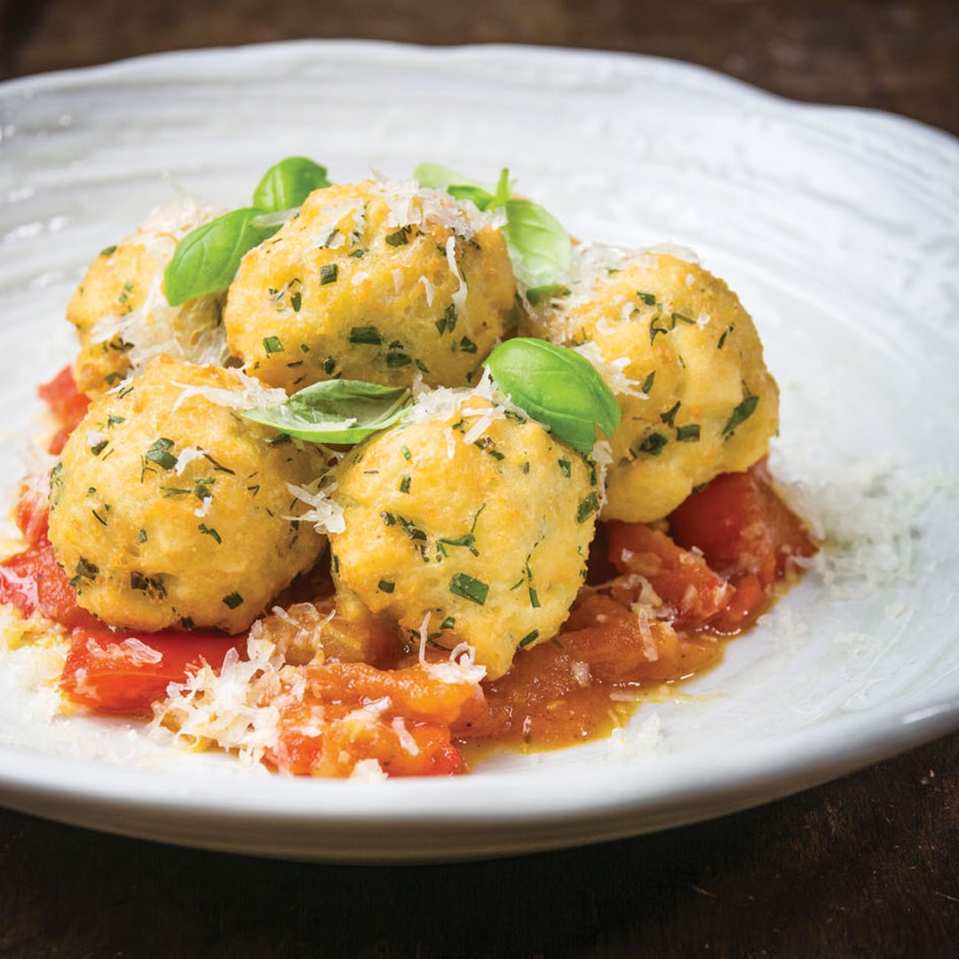 Bread and Grana Padano croquettes with fresh herbs, tomato and red pepper sauce