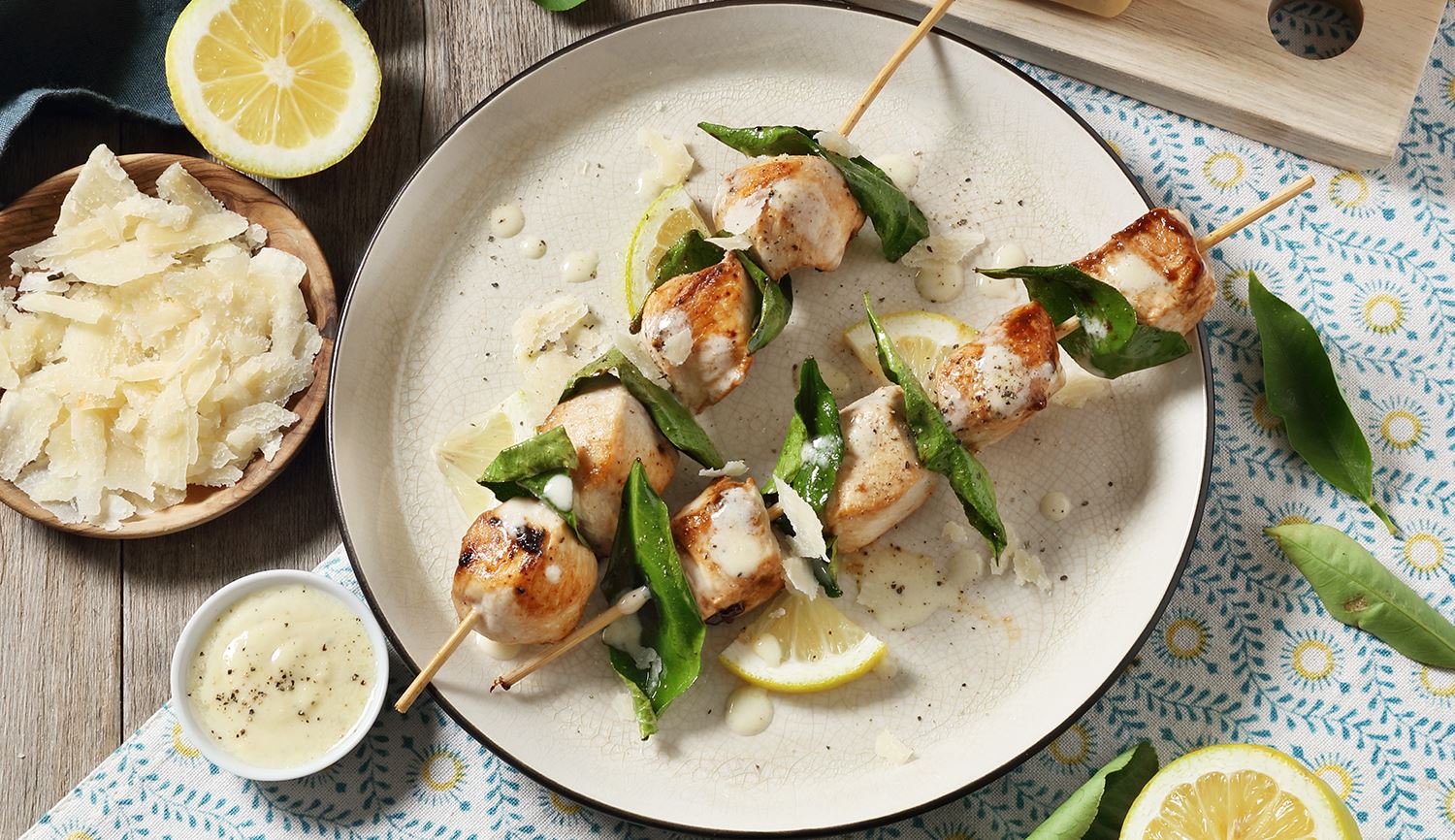 Brochetas de pollo a la parrilla con hojas de limón y crema de Grana Padano