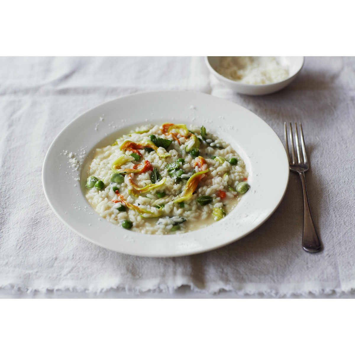 Risotto with broad beans, peas, courgette flowers, Grana Padano and mint