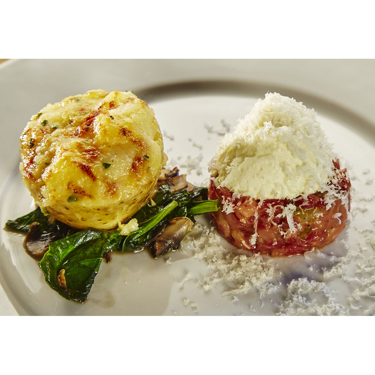 Stuffed potatoes with grappa, Grana Padano mousse, spinach and beef tartare